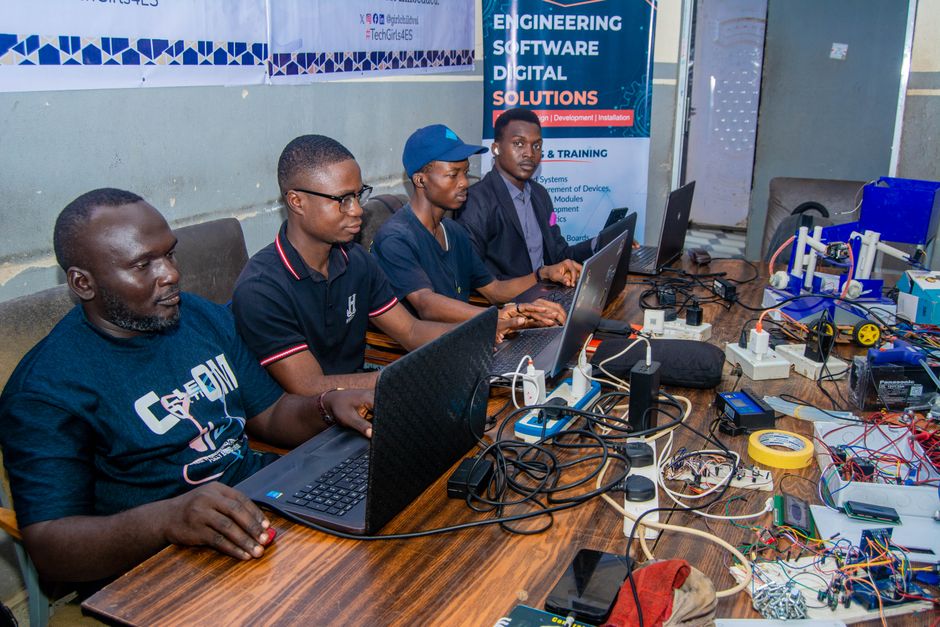 Group of engineers working together on digital solutions in a collaborative workspace.